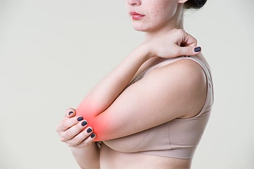 Woman with pain in elbow, joint inflammation