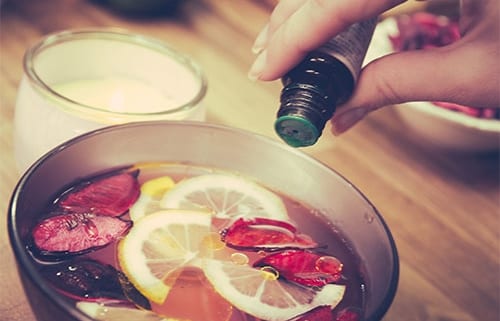 pouring essential oil into a bowl